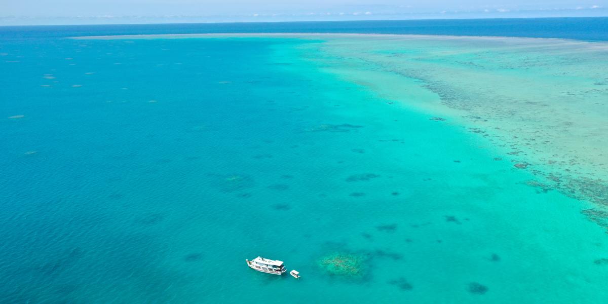 aerial of reef with recreational boat